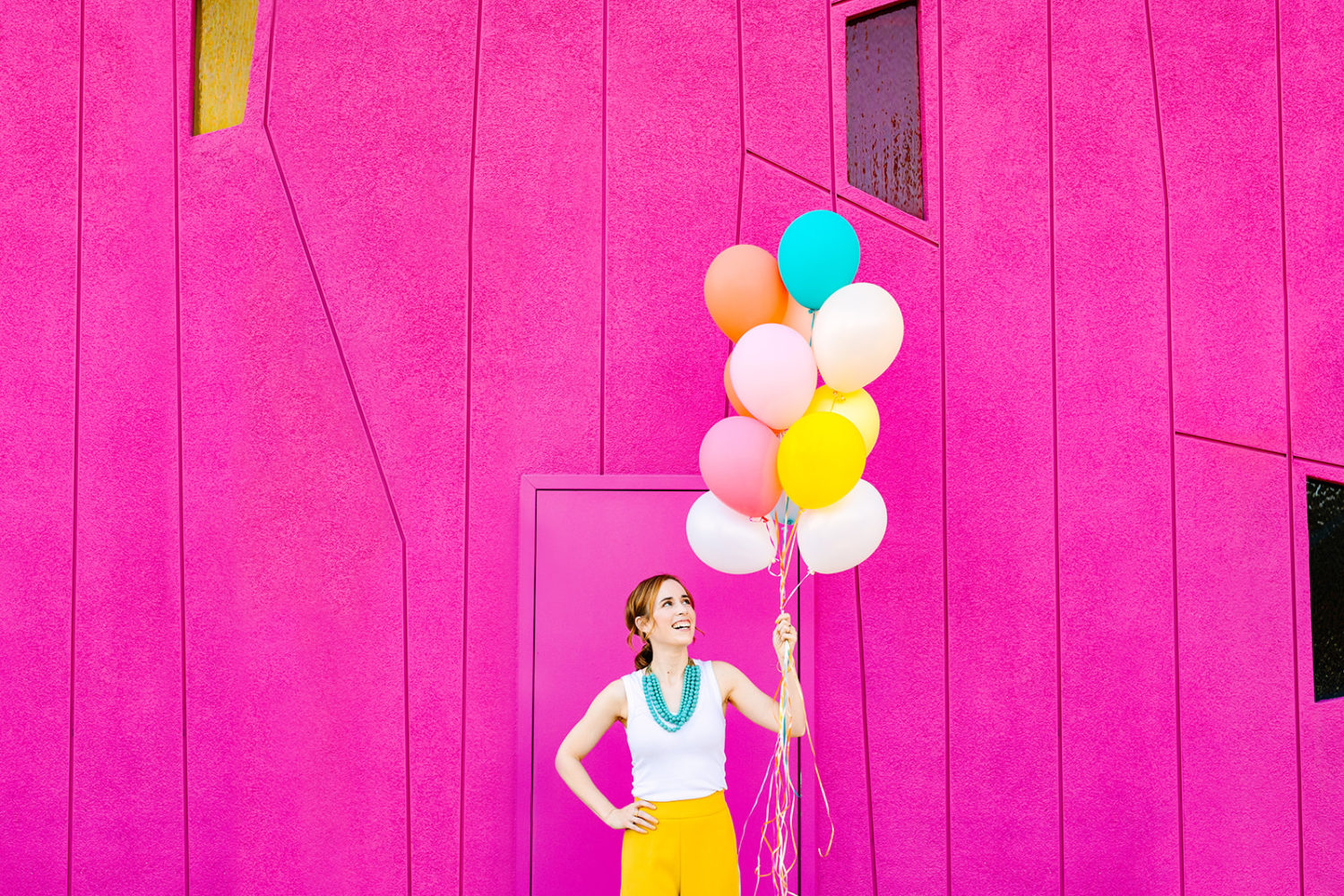 Pink wall with colorful balloons