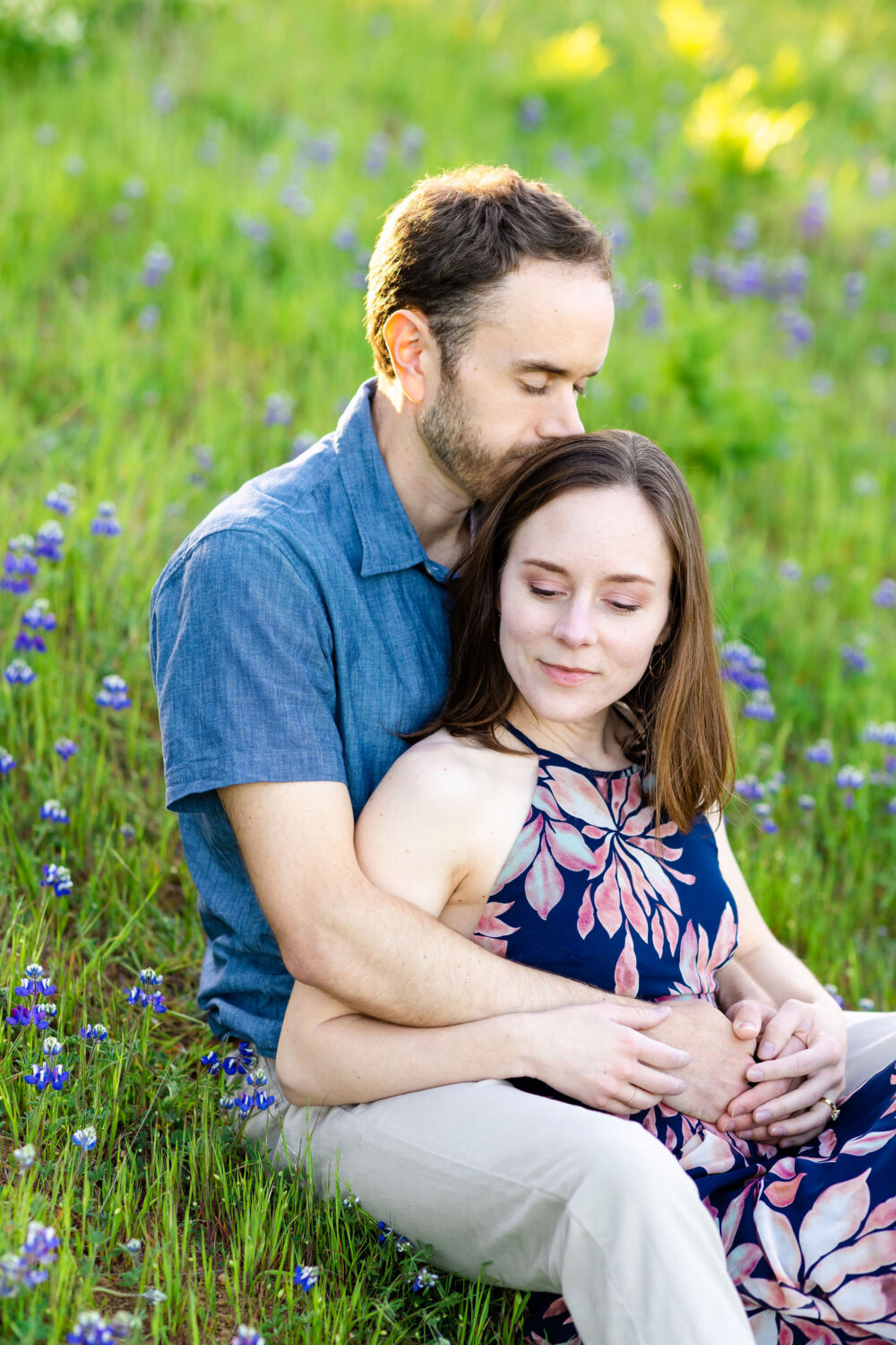 San francisco bay area engagement photos on mount tamalpais in Marin. The couple wears blue outfits and sits in a field of wild iris.